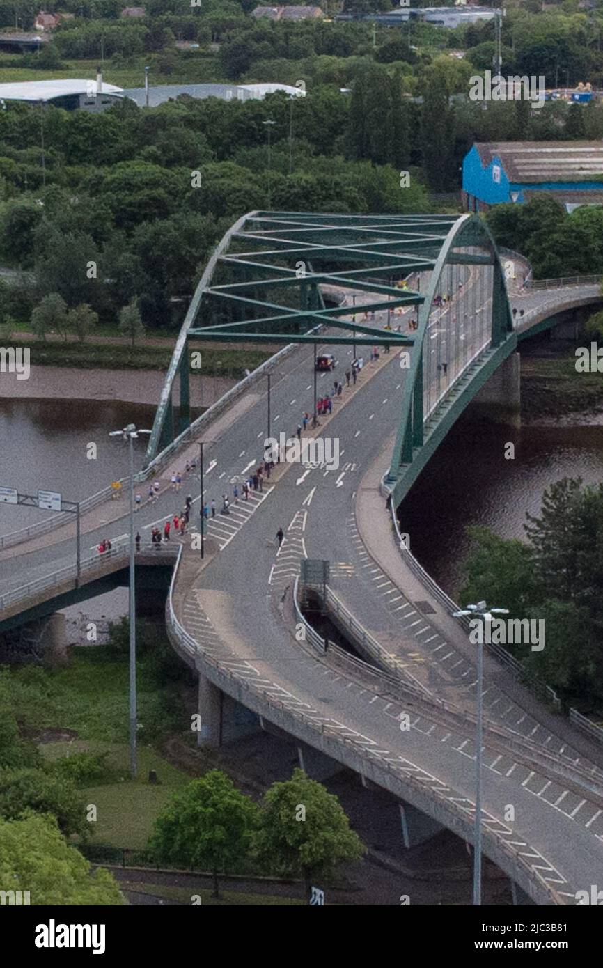Blaydon, England, 9 June 2022. Aerial view of lead runners crossing the River Tyne on Scotswood Bridge during the annual Blaydon race from Newcastle to Blaydon. Credit: Colin Edwards/Alamy Live News. Stock Photo