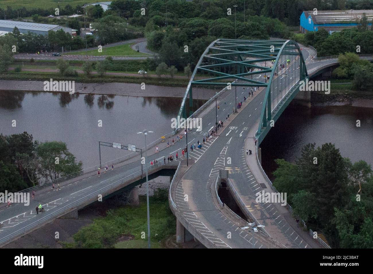 Blaydon, England, 9 June 2022. Aerial view of runners crossing the River Tyne on Scotswood Bridge during the annual Blaydon race from Newcastle to Blaydon. Credit: Colin Edwards/Alamy Live News. Stock Photo
