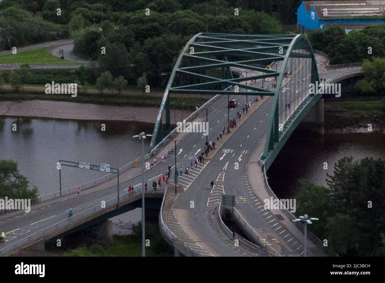 Blaydon, England, 9 June 2022. Aerial view of lead runners crossing the River Tyne on Scotswood Bridge during the annual Blaydon race from Newcastle to Blaydon. Credit: Colin Edwards/Alamy Live News. Stock Photo