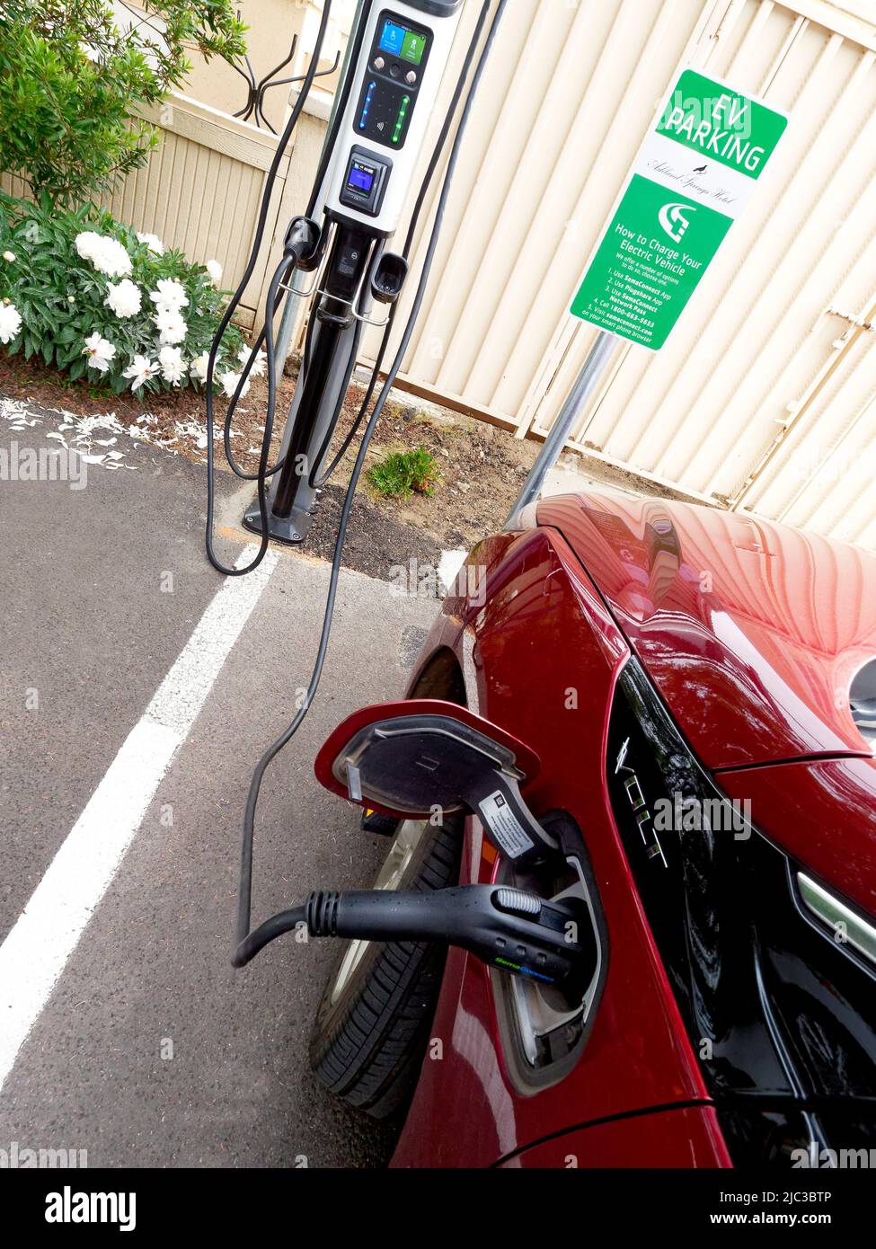 In Ashland, Oregon, the hotel Ashland Springs provides four charging stations for electric vehicles. Symbol on parking space reserved for the electric cars (Chevrolet Volt seen charging) Stock Photo
