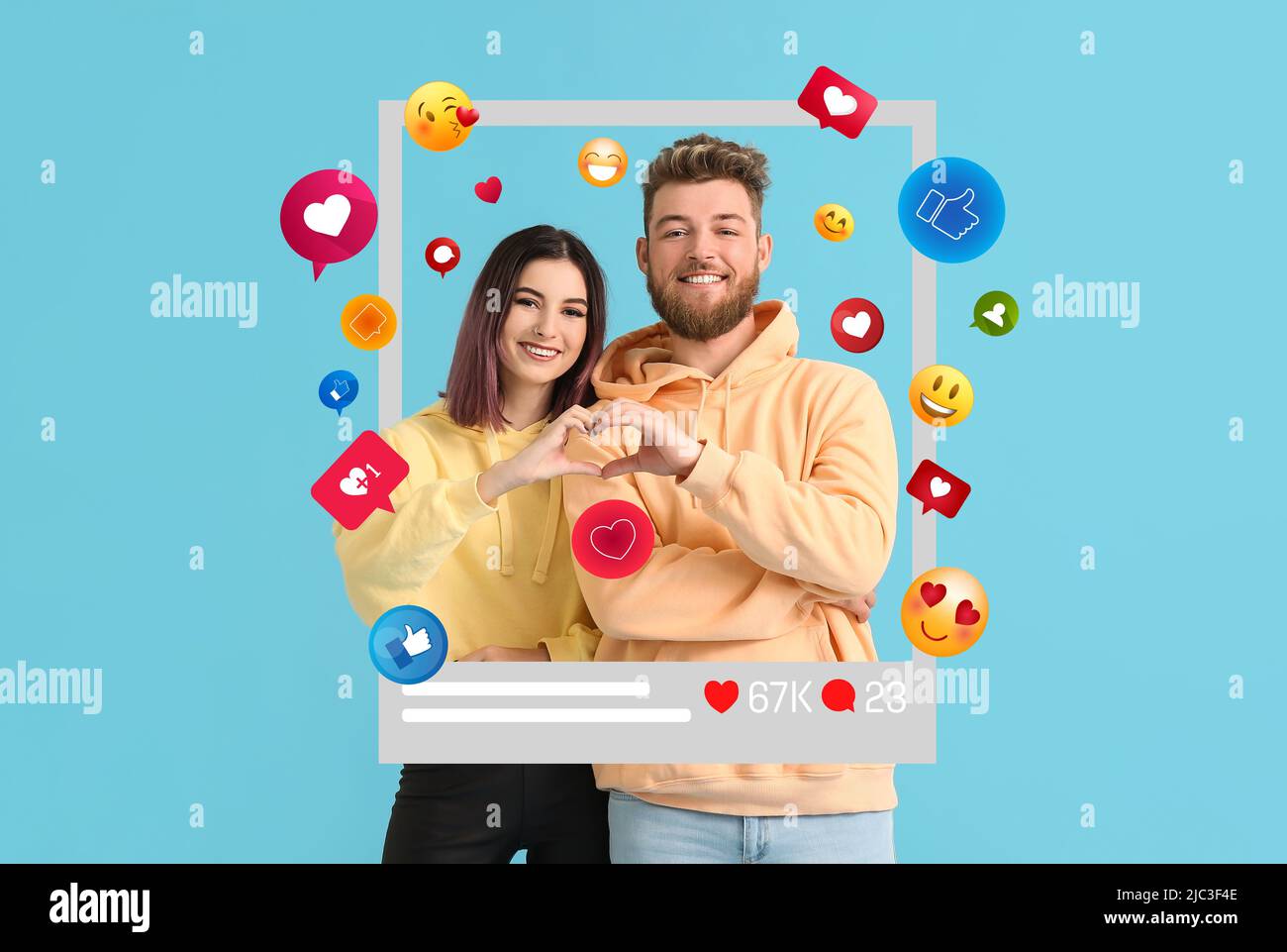 Happy young bloggers showing heart shape with their hands on blue ...