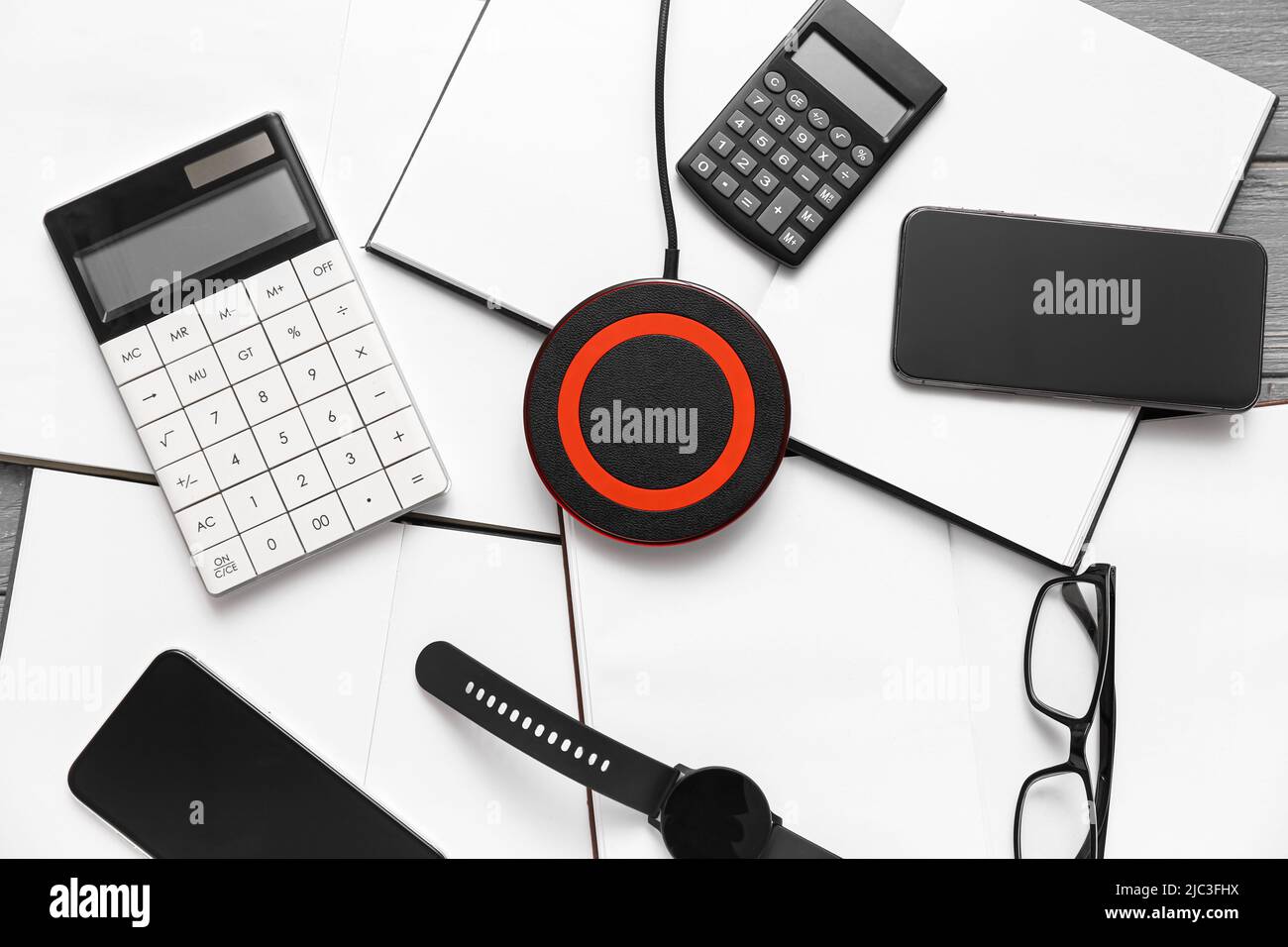 Wireless charger pad, gadgets and calculators on table Stock Photo