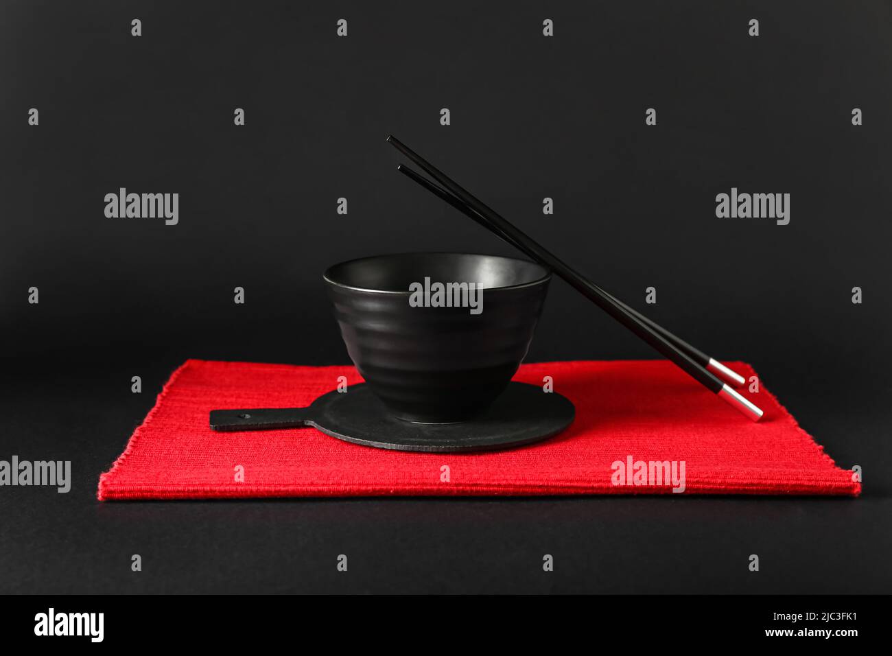 Chinese bowl with chopsticks on dark background Stock Photo Alamy