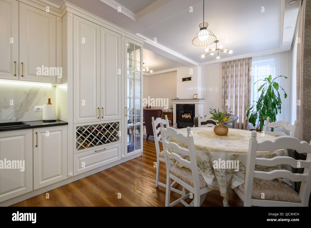 Modern classic large white colored luxurious kitchen and dining room in ...