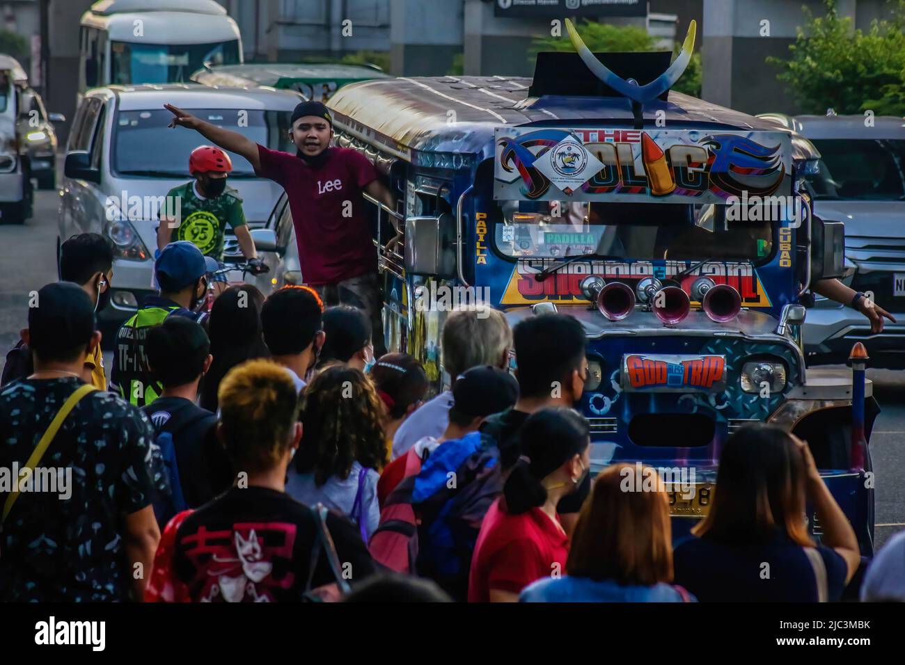 Commuters are seen waiting for the coming jeep manned by a jeepney dispatcher. Diesel fuel, most commonly used for Public Utility Jeepneys (PUJ), a passenger-type jeep, hiked to almost 7 Pesos and reached 75 to 87 Philippine Peso (1.45 to 1.64USD) per liter that caused it's net increase to 36 Pesos. Some jeepney drivers are still halting their trips due to the continues oil price increases. Stock Photo
