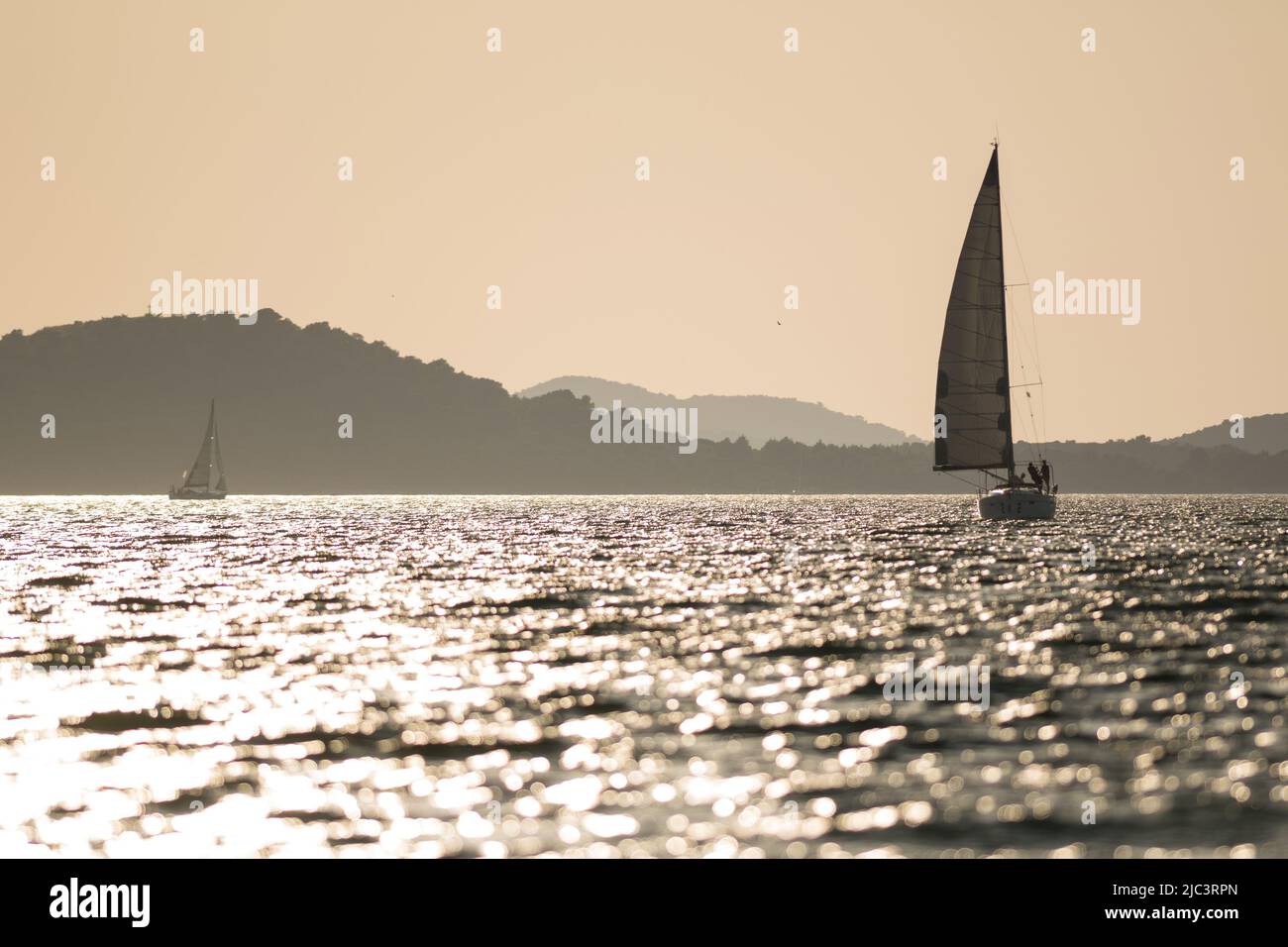 Sailing yachts at sea during sunset Stock Photo
