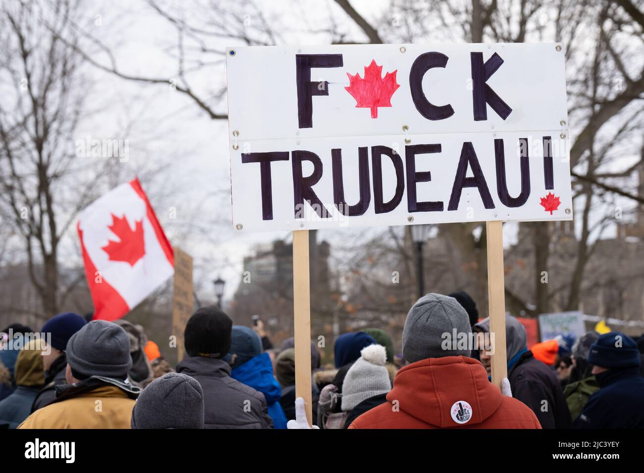 A protestor holds up a F*ck Trudeau sign during a Freedom Rally against all COVID-19 mandates at Queen's Park in Toronto, Ontario. Stock Photo