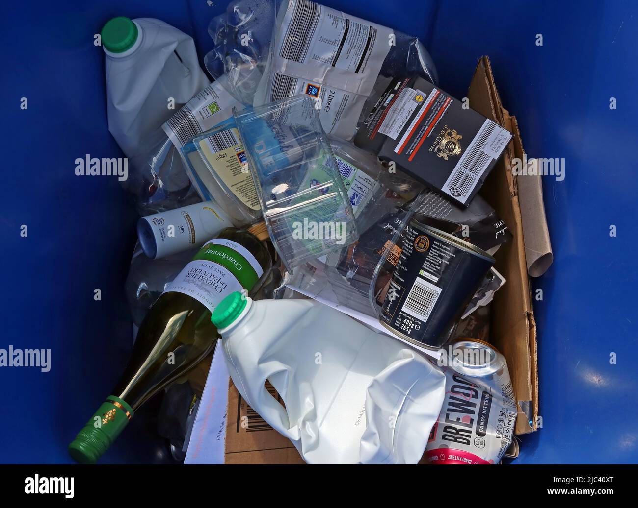 Typical blue wheelie bin recycling mix, plastic, paper, cartons, glass bottles etc Stock Photo