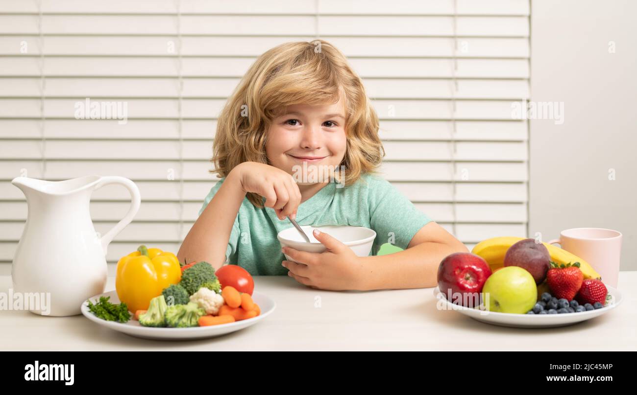 Kid preteen boy 7, 8, 9 years old eating healthy food vegetables