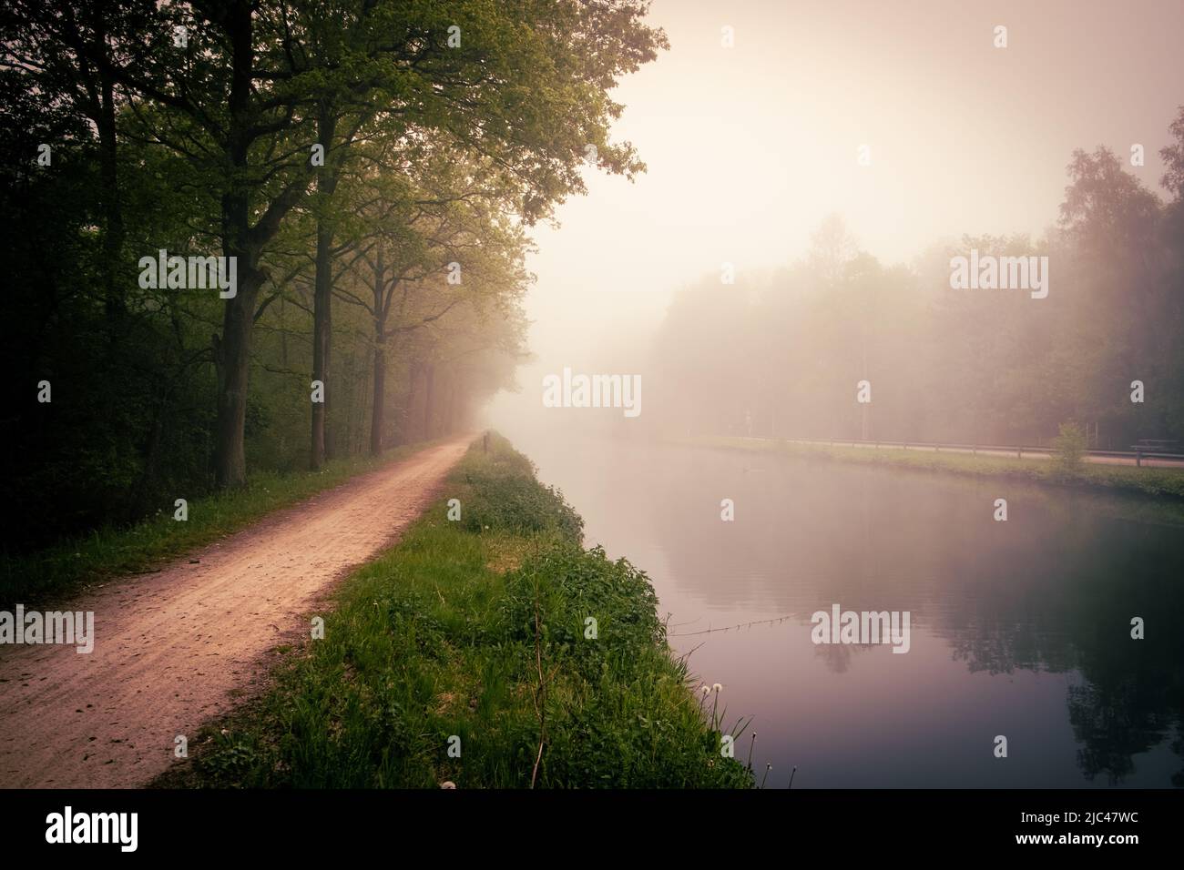 Beautiful spring sunrise over river banks. Morning fog in the forest ...