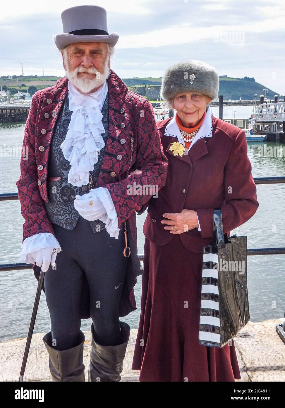 Reenactors portray a 1620 man and woman at the Mayflower Steps in Plymouth, Devon, England, UK. Stock Photo
