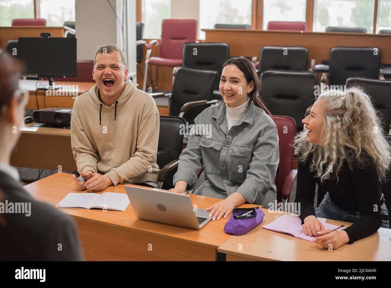 The teacher and students communicate in sign language in the classroom. Hearing impaired and