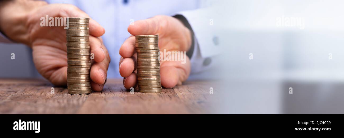 Close-up Of A Person's Hand Holding Stack Of Coins Stock Photo