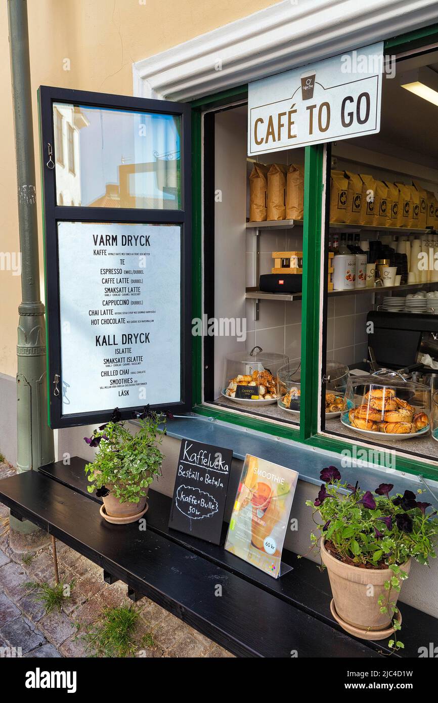 Decorated open window of a cafe with menu, cold and hot drinks, baked goods and sign Coffee to go, Old Town of Visby, Gotland Island, Sweden Stock Photo