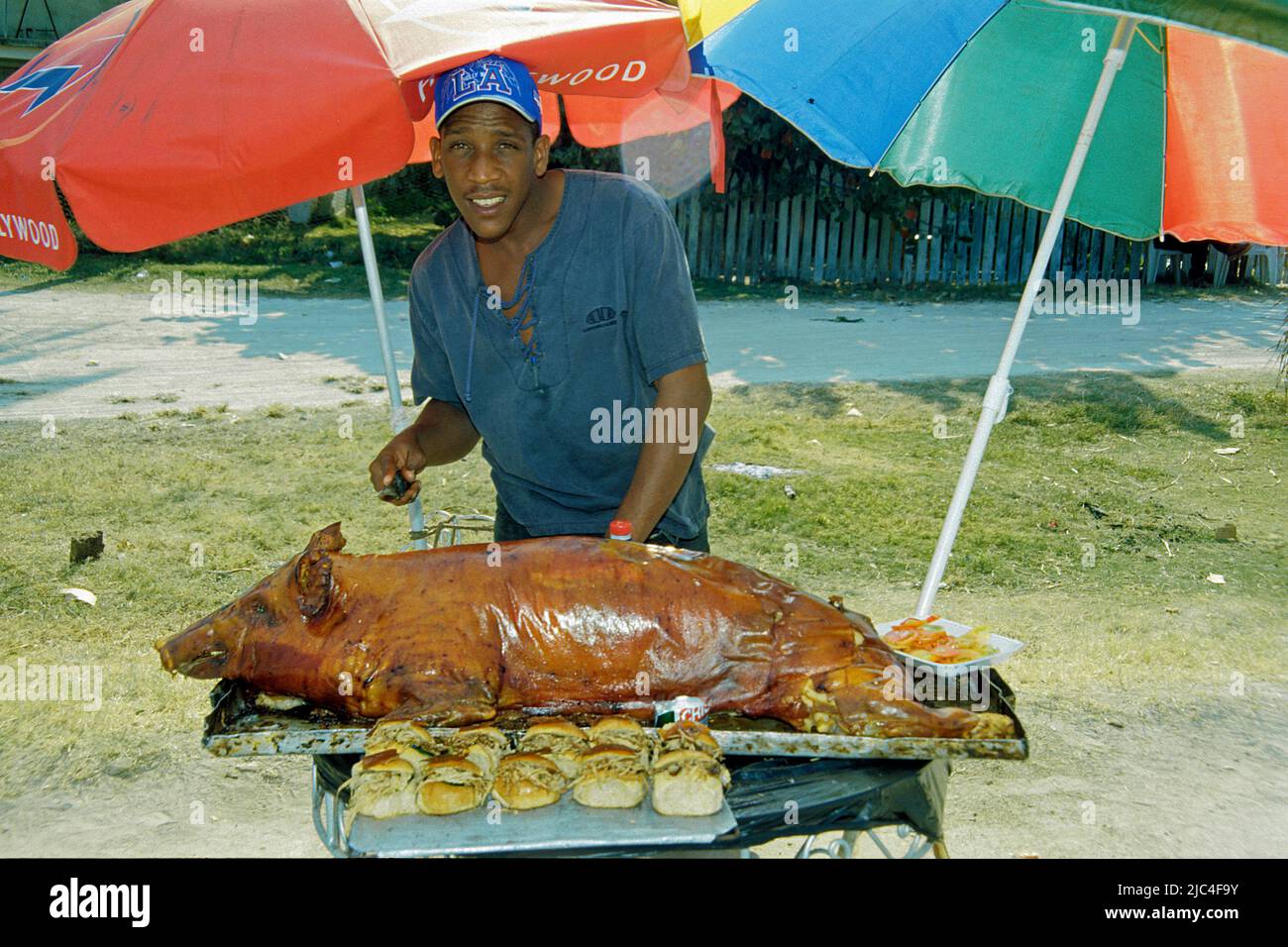 Cuban man with pig roast at a festival, St. Lucia, Cuba, Caribbean Stock Photo