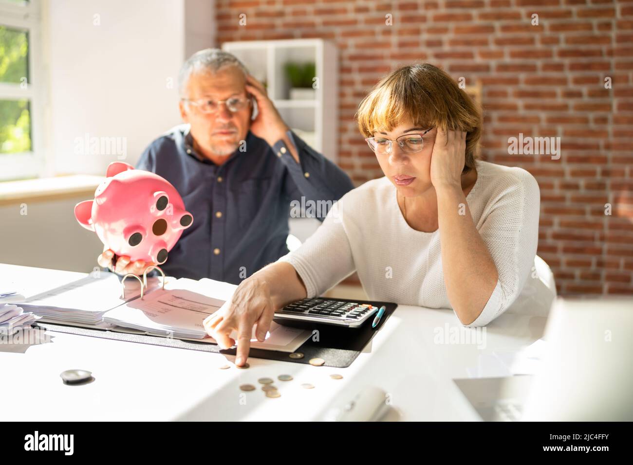 Portrait Of A Couple Sitting On Couch Enjoying Success Stock Photo
