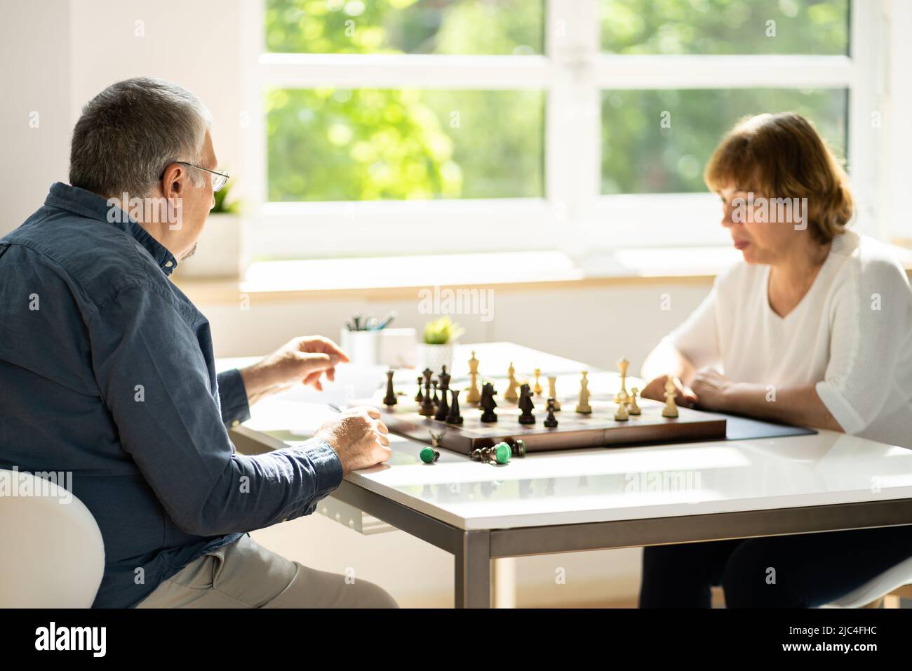 Elderly Senior Playing Chess Table Board Game Stock Photo