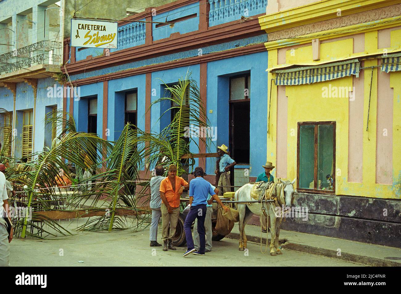 Cuban men at a horse-drawn carriage in a alley of Trinidad, Unesco World Heritage Site, Cuba, Caribbean Stock Photo