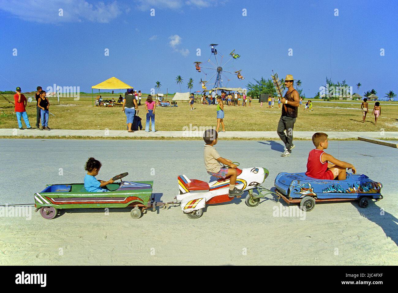 Cuban kiddies driving nostalgic toy cars, festival in St. Lucia, Cuba, Caribbean Stock Photo