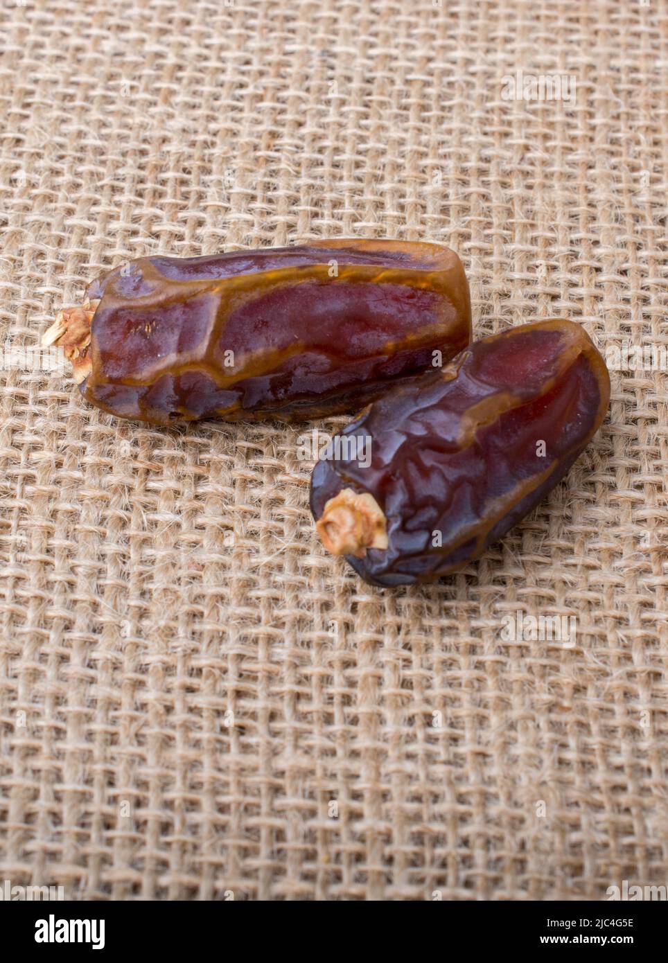 Date fruit placed on a linen canvas background Stock Photo