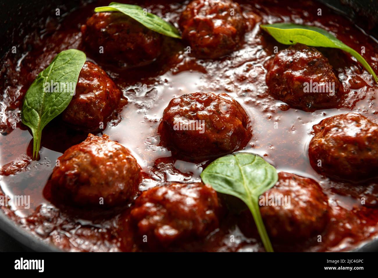 Meat balls in tomato sauce with basil Stock Photo Alamy