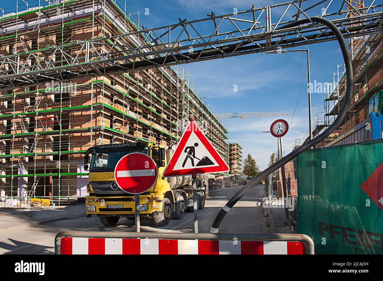 New construction of residential and commercial building, construction site vehicle, large construction site, Munich, Bavaria, Germany Stock Photo
