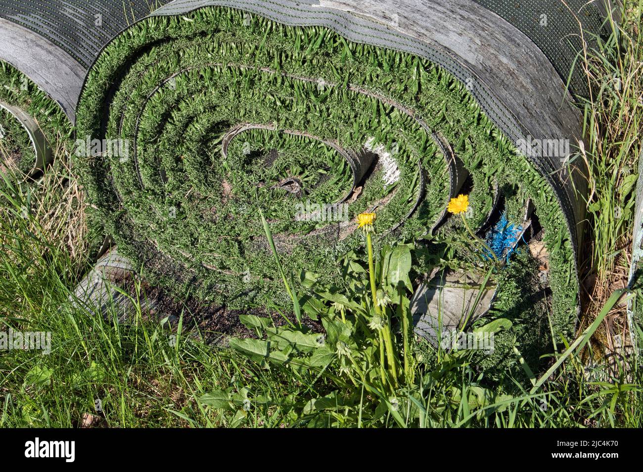 Rolls of old artificial grass outdoors Stock Photo