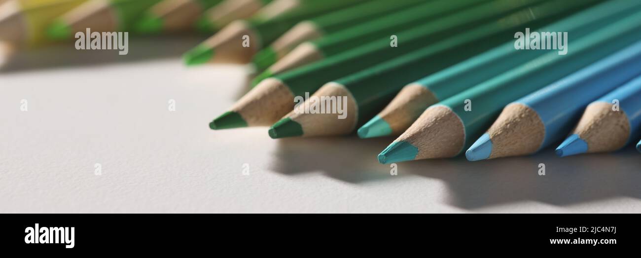 Colored pencil set loosely arranged on surface and not arranged exactly in row Stock Photo