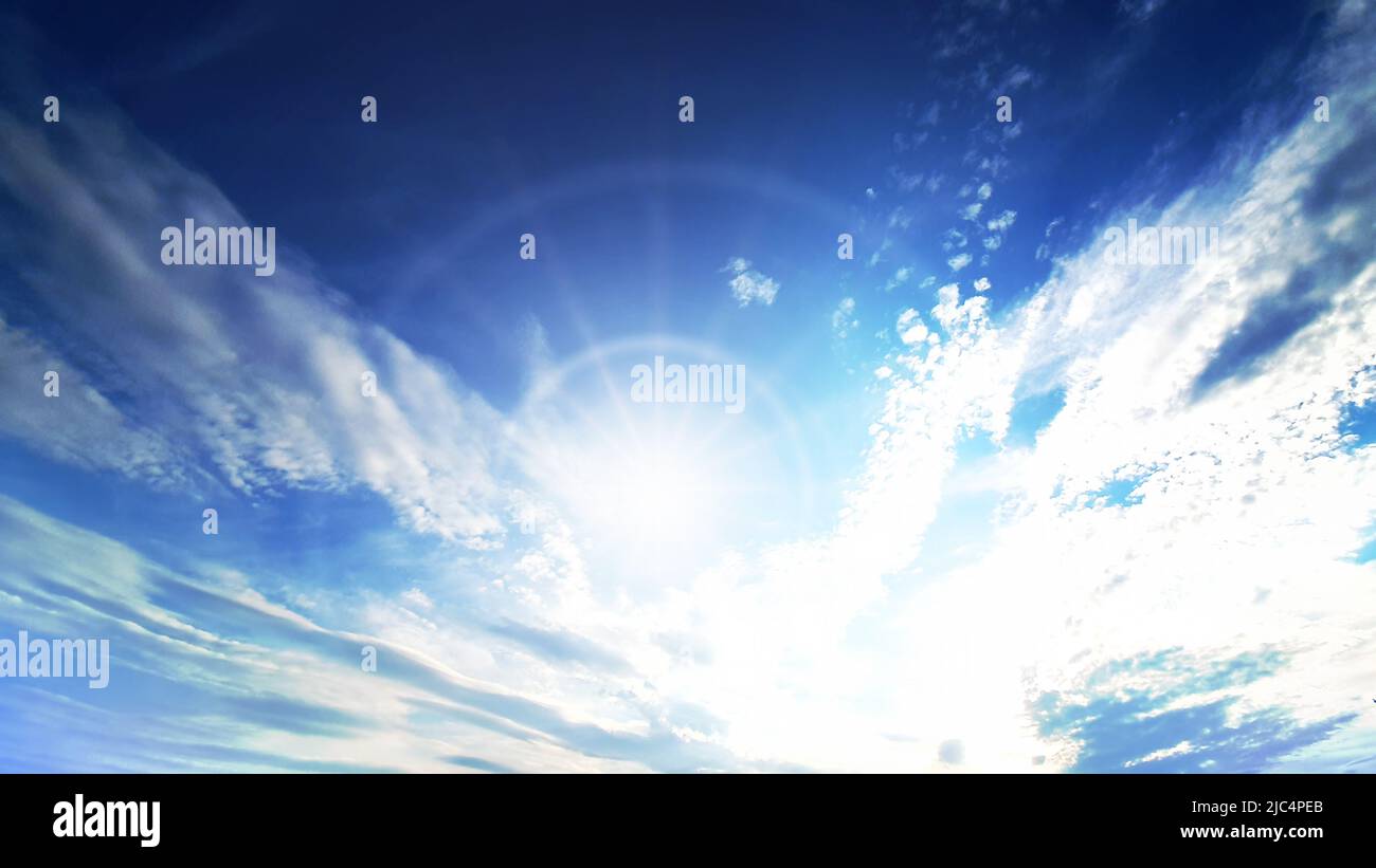 Sunny background, blue sky with white clouds and sun Stock Photo - Alamy