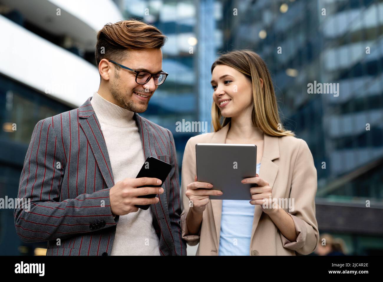 Portrait of successful business people working, talking together in urban background. Stock Photo