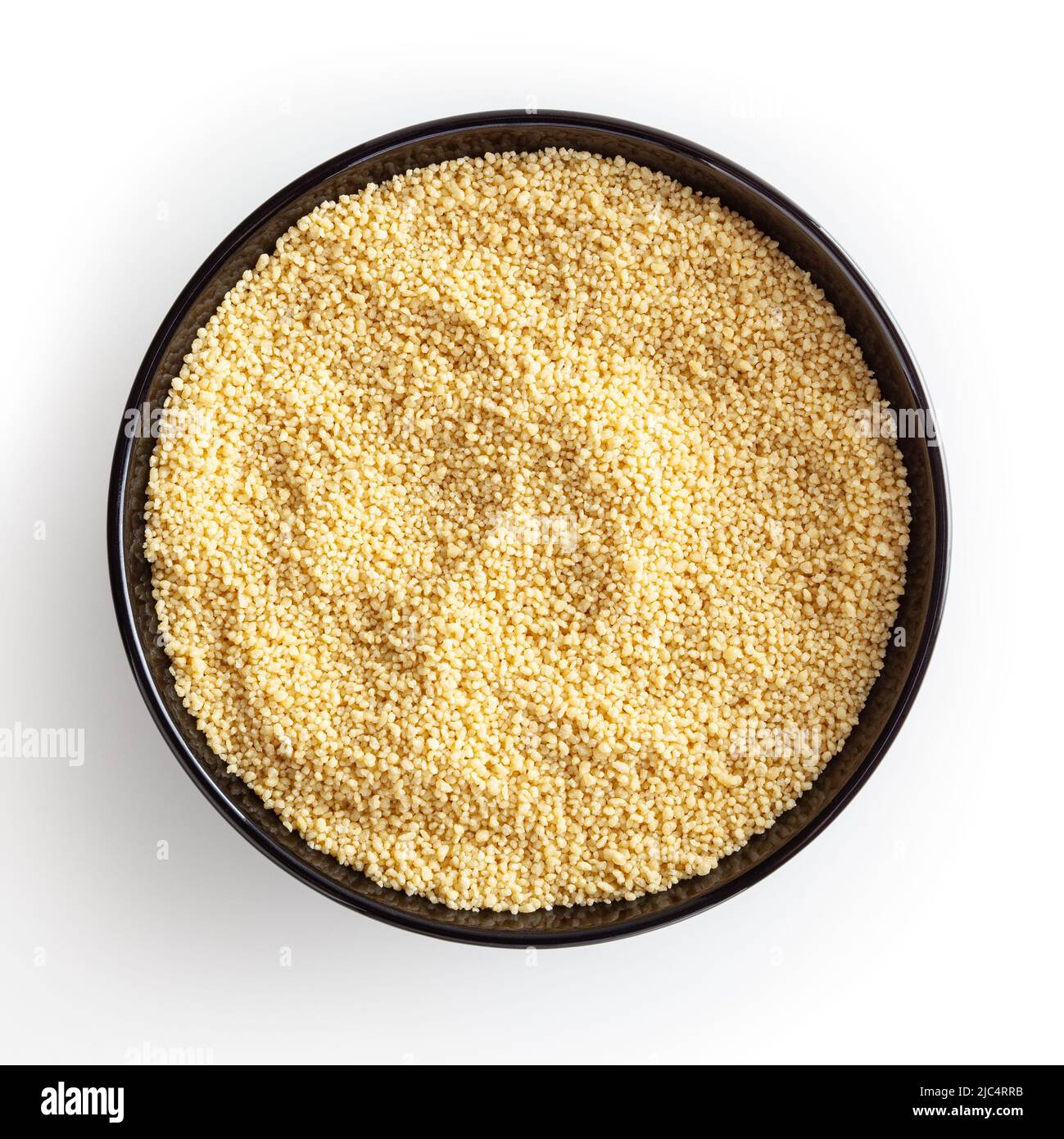 Uncooked couscous in black bowl isolated on white background with