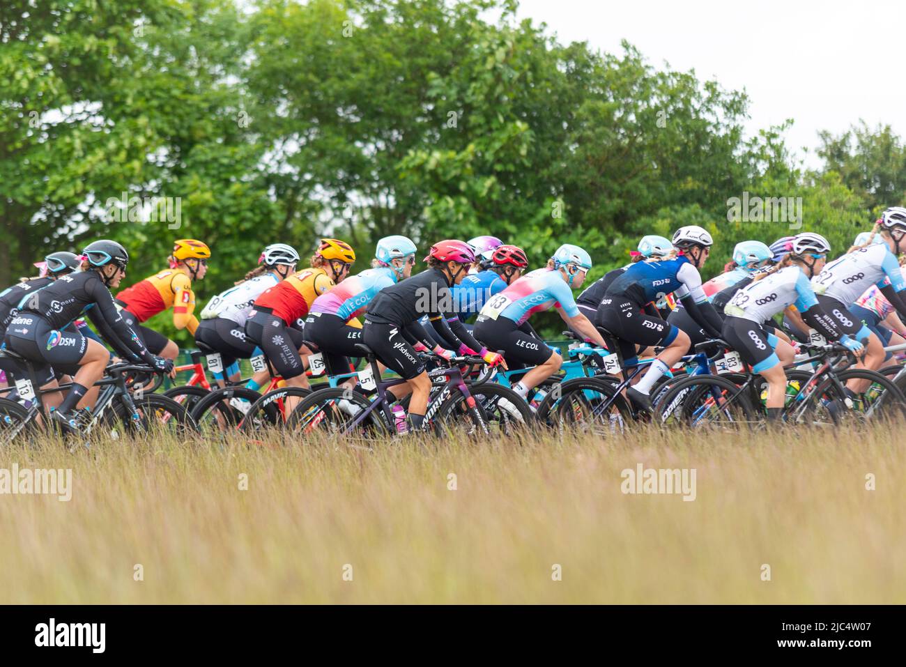 Cyclists at Colchester Sports Park racing in the UCI Women’s Tour cycle race Stage 1 heading out into Essex countryside. Stock Photo