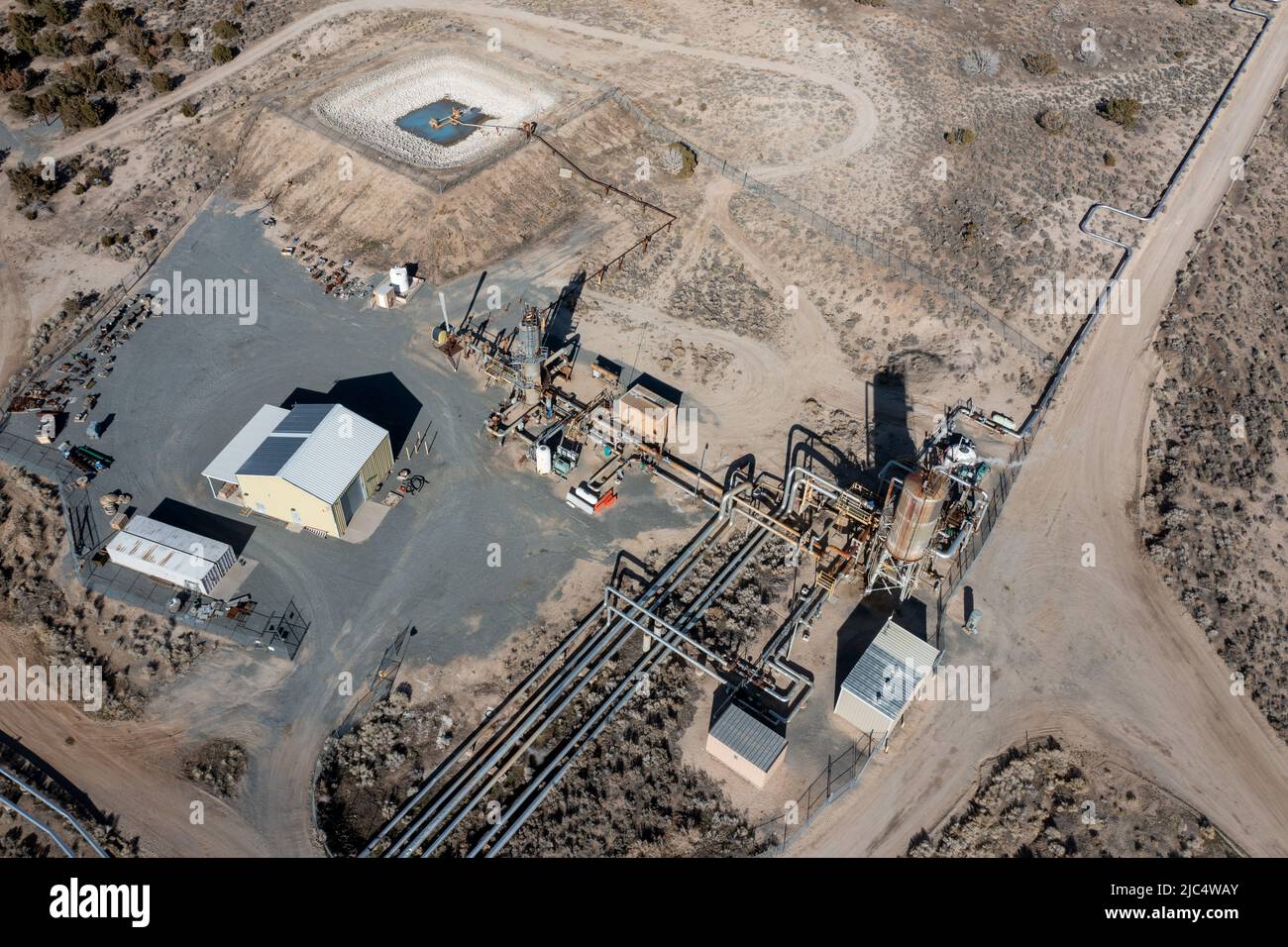 Aerial view of a production well and piping for a return injection well
