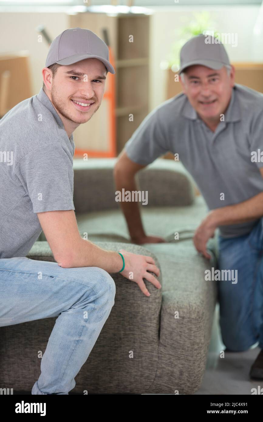 men delivering a new sofa to a property Stock Photo