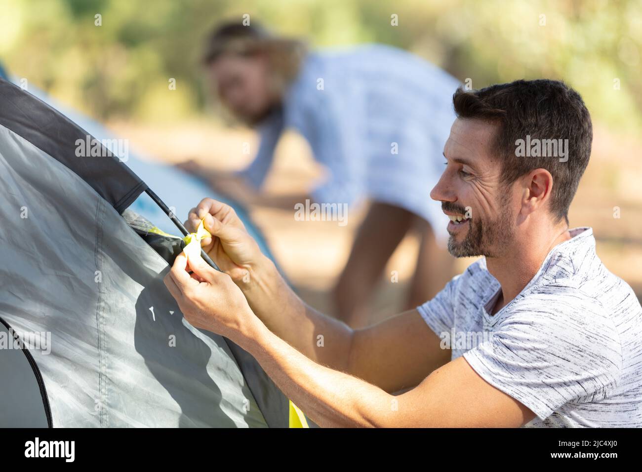 Couple of travellers making a tent stock photo alamy