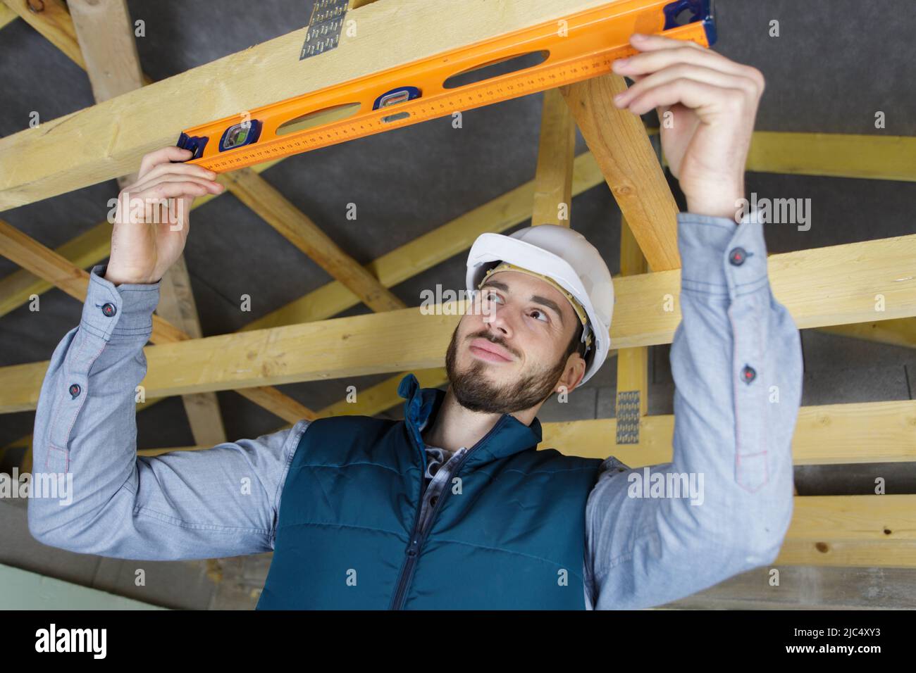 male construction worker adjusting ceiling part Stock Photo