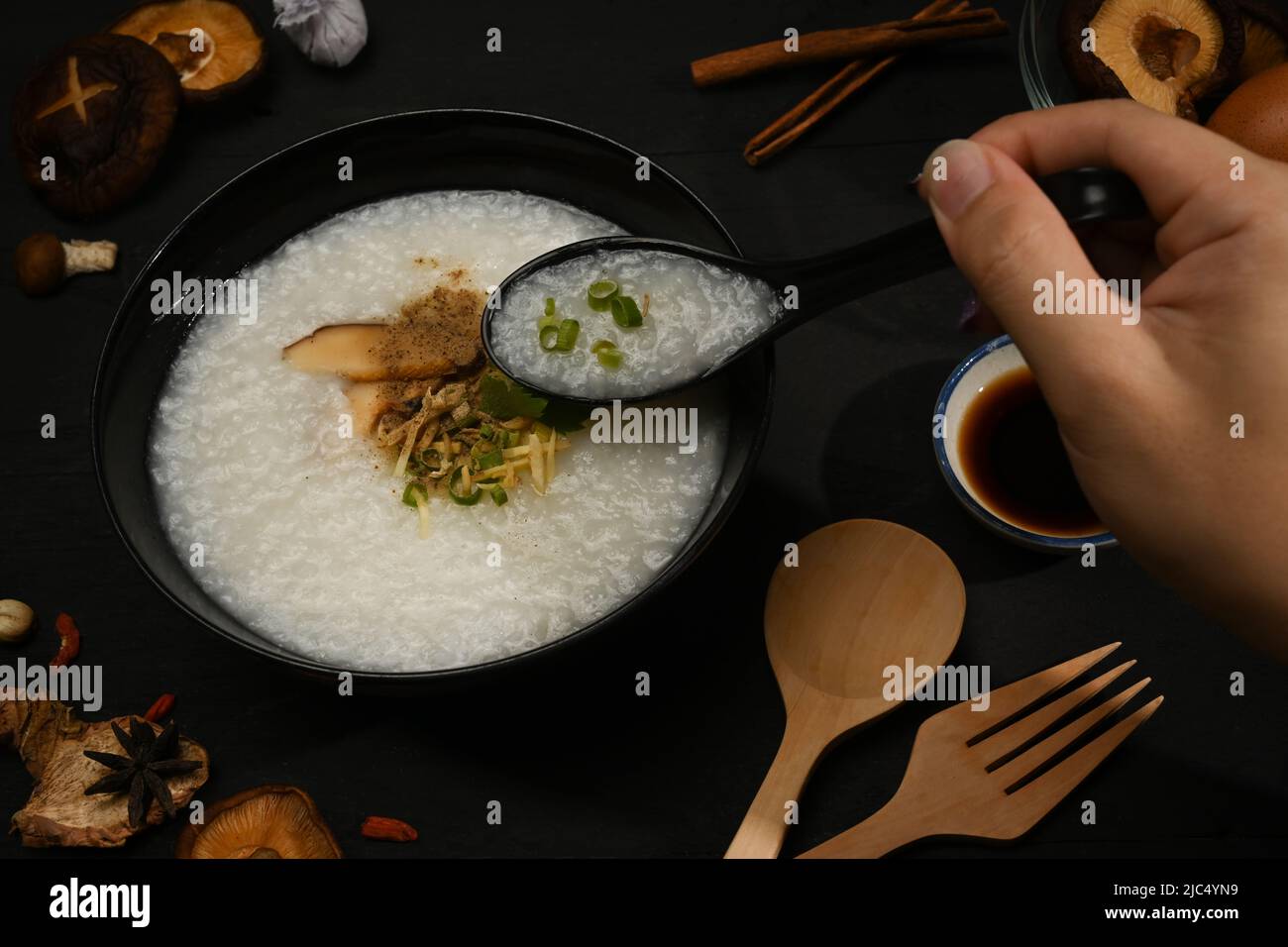 A bowl of nutritious rice porridge served with side dishes for breakfast or light meal Stock Photo