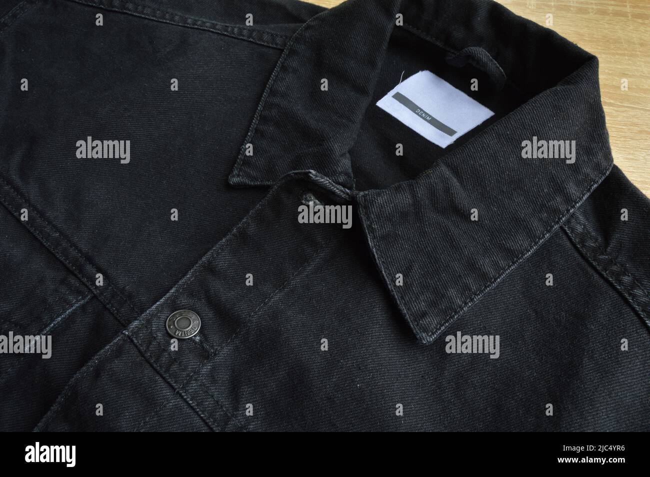 Black jeans denim coat jacket and botton, empty blank sale tag Stock Photo