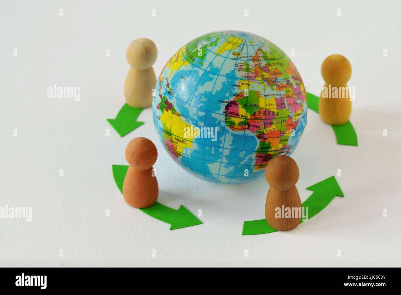 Pawns in a circle around earth glibe - Concept of globalization and teamwork Stock Photo