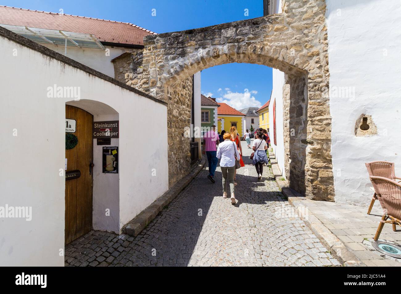 People walking through old town gate of the wall around Rust am See (build in 1512), Rust, Burgenland, Austria Stock Photo