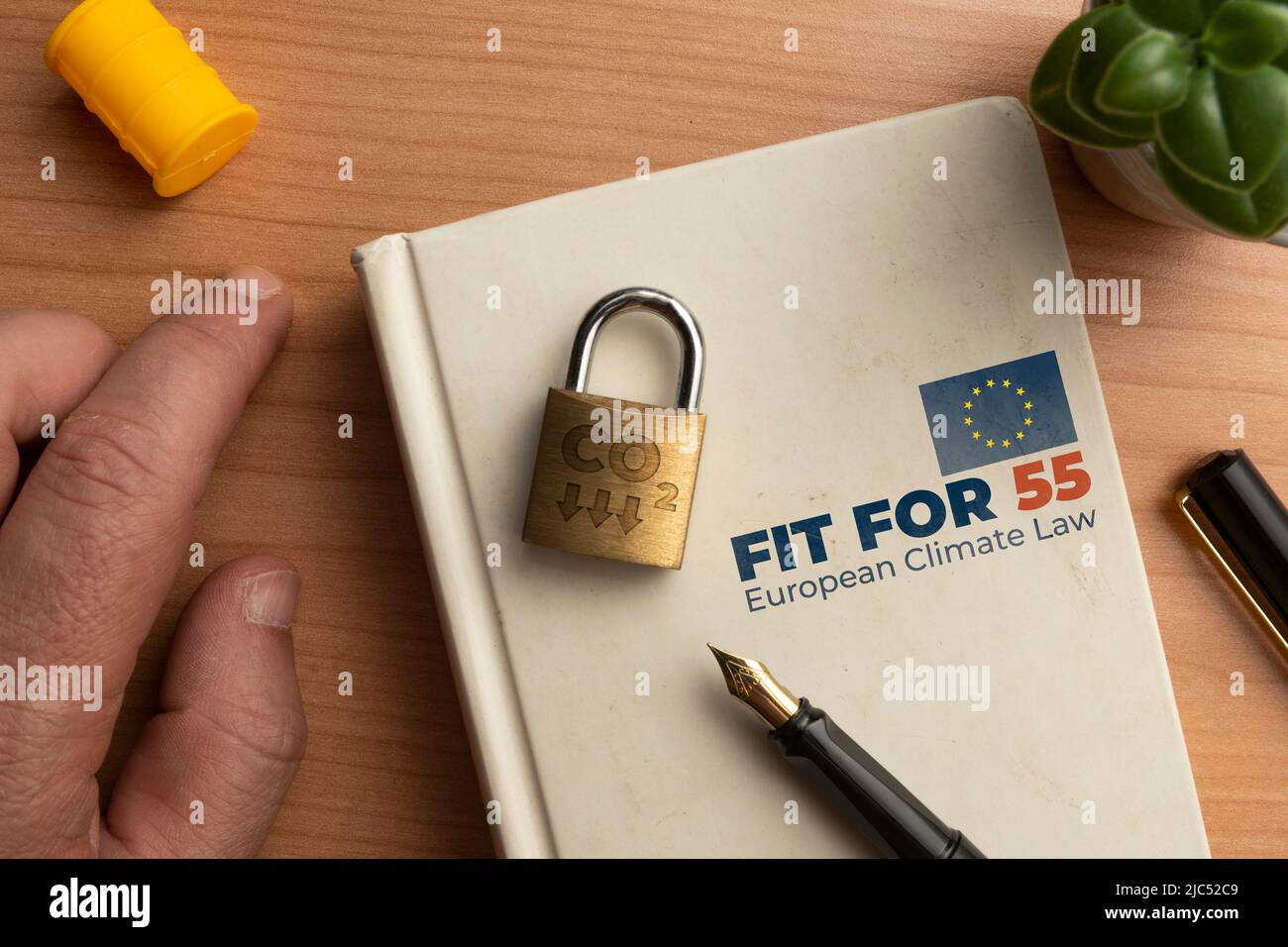 Fit for 55 european climate law concept: a book on a wooden table with ...