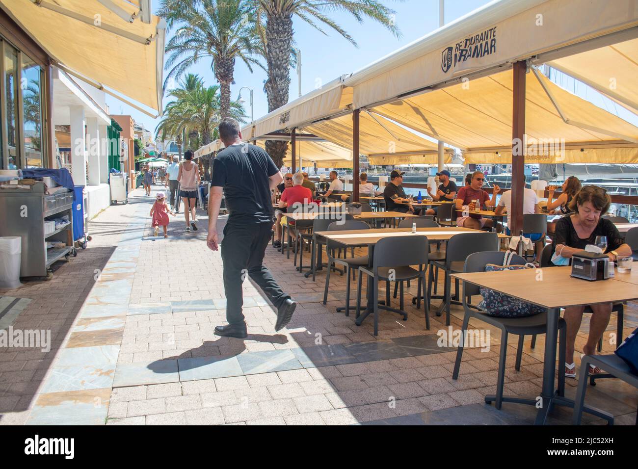 Restaurant tables set on the water front at Cabo de Palos, Murcia, Spain Stock Photo