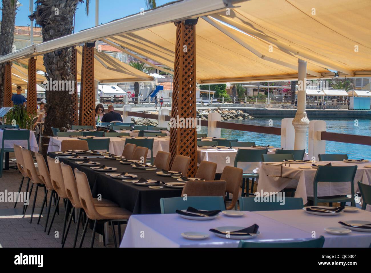 Restaurant tables set on the water front at Cabo de Palos, Murcia, Spain Stock Photo