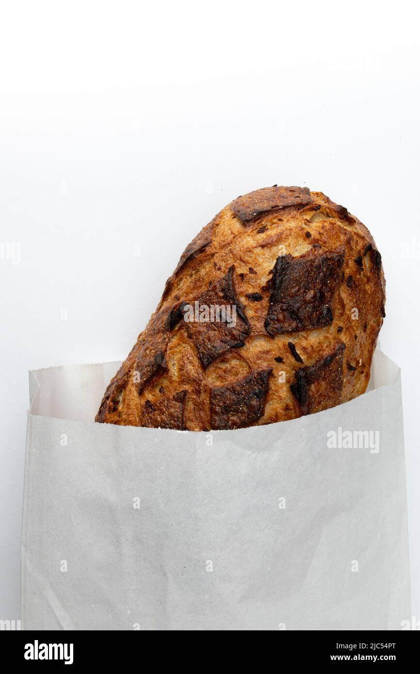 homemade freshly baked traditional bread in paper bag isolated on white