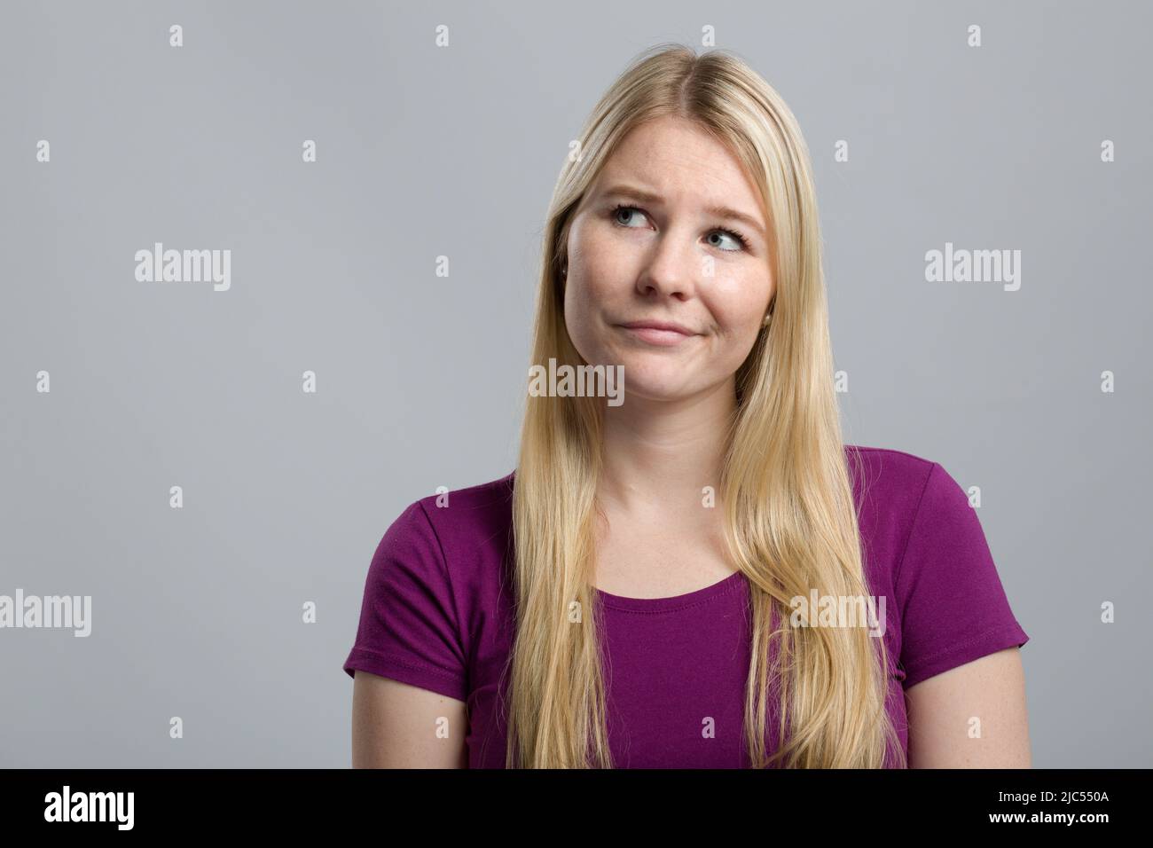 young woman is thinking and shows emotional expressions Stock Photo
