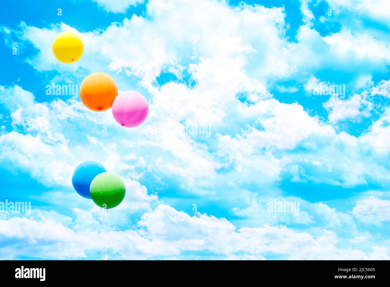 Five colorful air balloons over blue sky and white clouds. Stock Photo