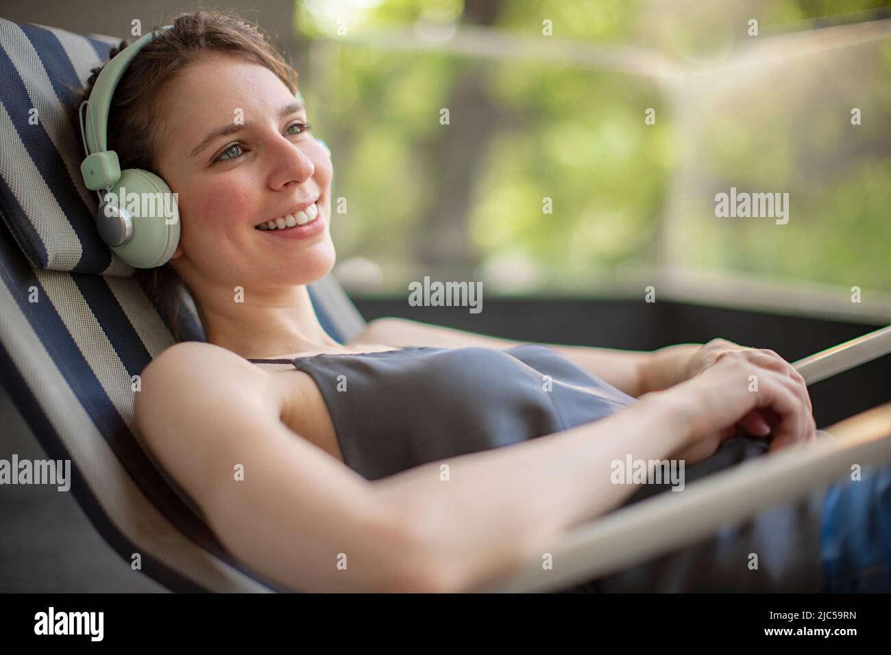 Closeup of a young woman listening to music on headphone Stock Photo