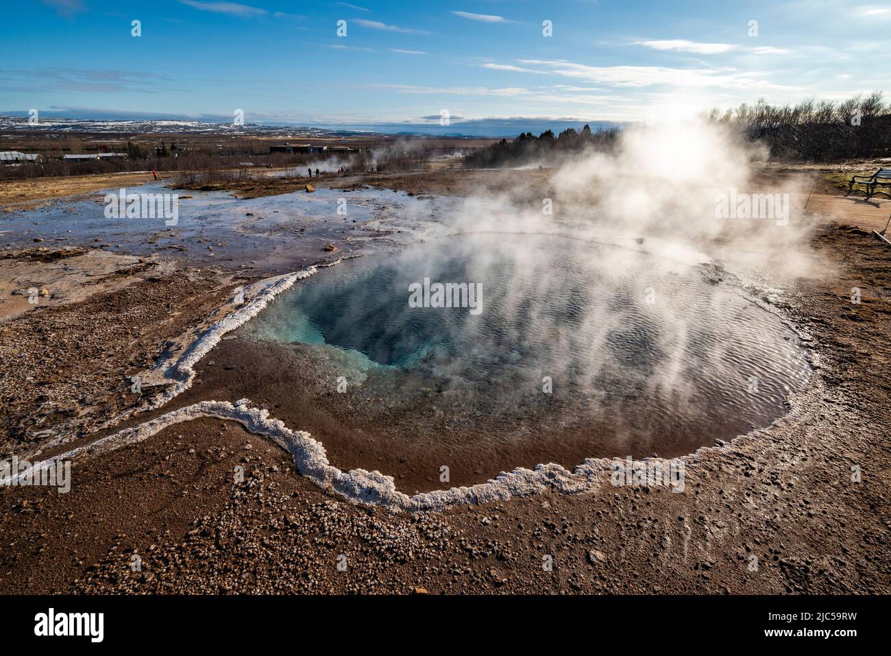 Steam rises over the magical blue water of Blesi hot spring in Haukadalur valley, Golden Circle Route, Iceland Stock Photo