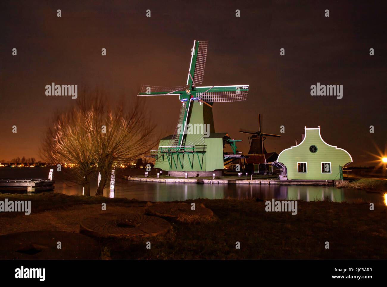 Paltrok mill De Gekroonde Poelenburg in floodlight *** Local Caption ***  Netherlands,windmill, water, winter, night, evening, ,Zaandam,   Noord-Holla Stock Photo