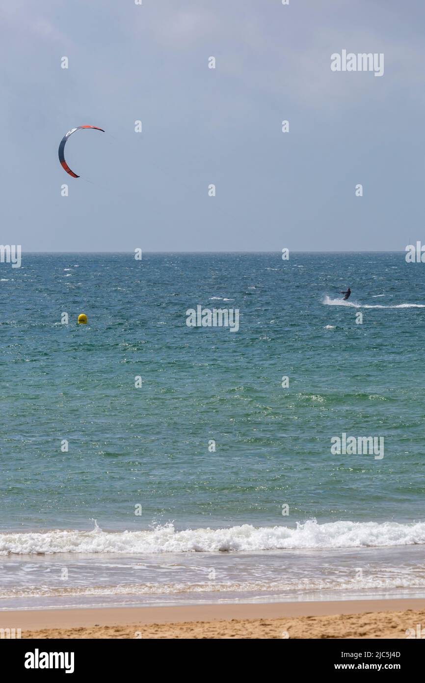 Branksome Dene Chine, Poole, Dorset UK. 10th June 2022. UK weather: sunny and breezy at Branksome Dene Chine beach. Man windsurfing. Credit: Carolyn Jenkins/Alamy Live News Stock Photo